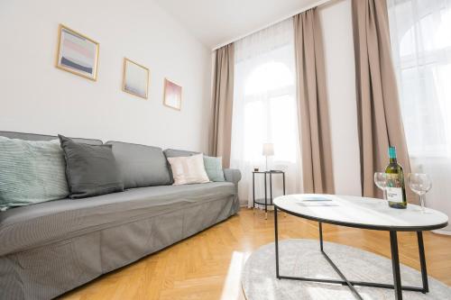 a living room with a couch and a table at Luxury Suites Liechtenstein in Vienna