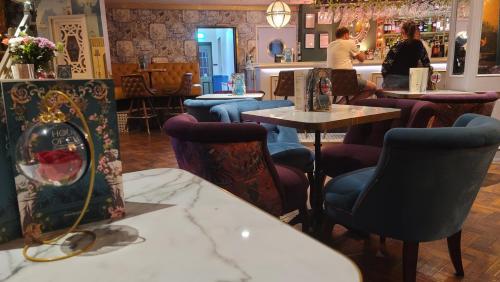 a restaurant with chairs and tables and a bar at Bingham Townhouse Hotel in Bingham