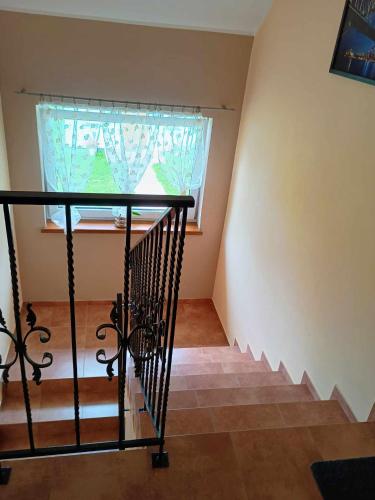 a staircase in a house with a window at W zieleni in Polanica-Zdrój