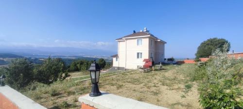 a house on a hill with a street light at Akkayalar Aerie House in Çepni