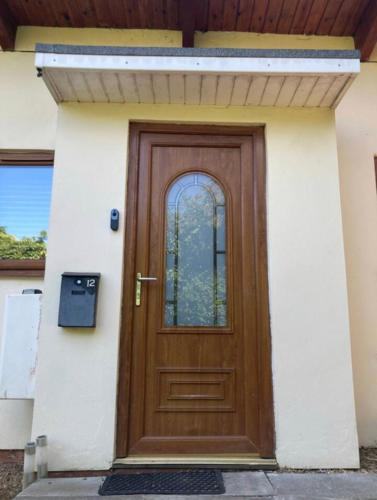 a wooden door on the side of a house at CV225AA 1 Bedroom-Near Rugby School-Ground Floor-WiFi-Self Check In in Rugby