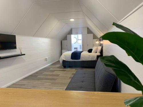 a bedroom with a bed and a tv in a room at The Loft Bredasdorp - Load Shedding Free in Bredasdorp