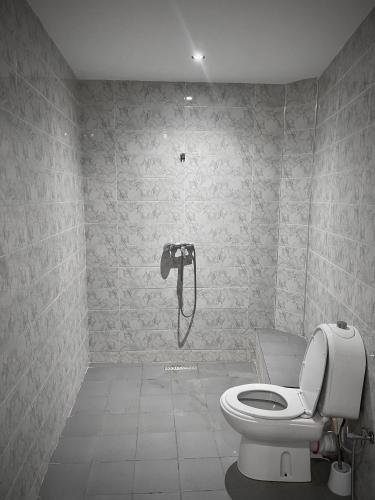 a bathroom with a toilet and a shower in it at MARRAKECH , Ourika in Ourika