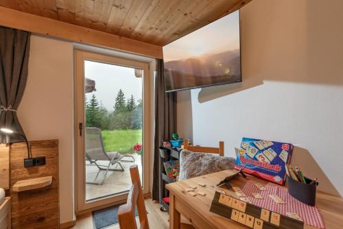 a tiny house with a desk and a window at Chalet der Erzstadl in Kirchberg in Tirol
