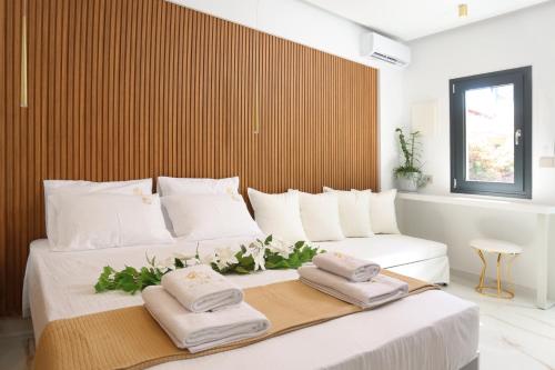 a bedroom with a large bed with towels on it at Mona Lisa in Pefkohori