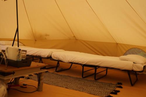 a room with three beds in a tent at Dartmoor Halfway Campsite in Newton Abbot