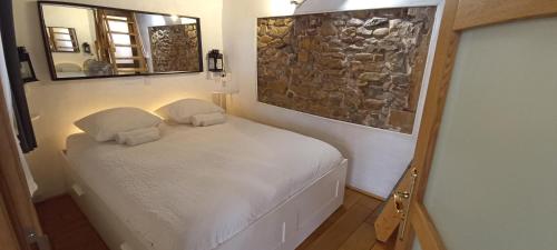 a bedroom with a bed with two pillows and a mirror at La Loge Du Vieux Lyon in Lyon