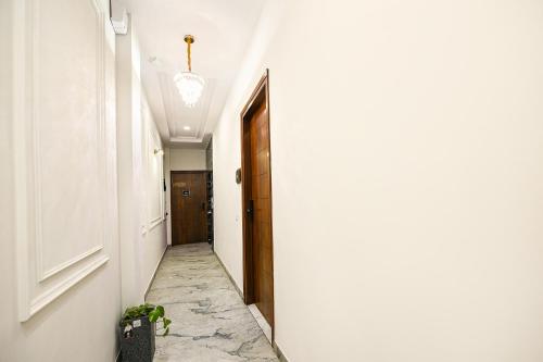 a hallway with a door and a tile floor at FabHotel K9 Ovilas in Ludhiana