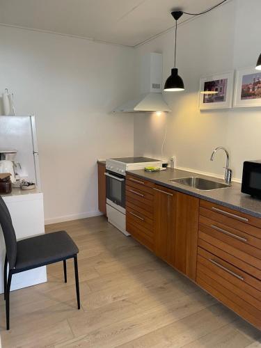 a kitchen with a sink and a stove at Hilmor's Lejligheder in Viborg
