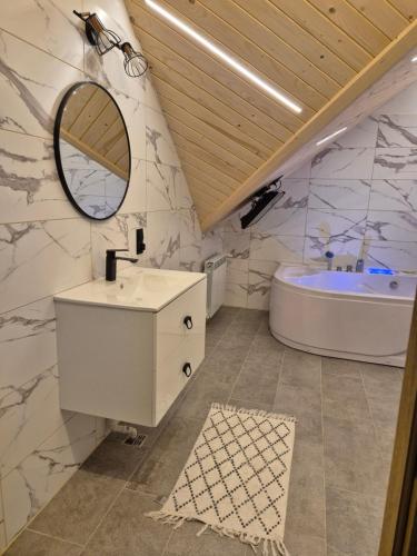 a bathroom with a sink and a tub at Apartament z prywatna wanną hydromasaż - U Parów in Białka Tatrzanska