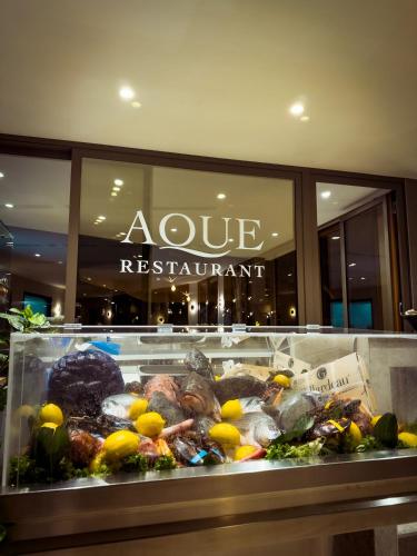 a display case of food in a restaurant at UNA HOTELS MH Matera in Matera