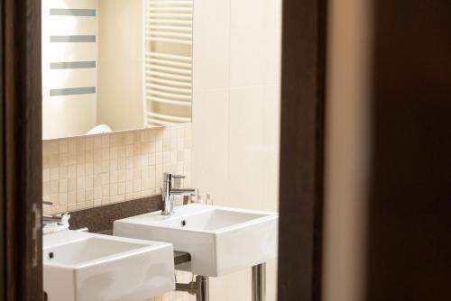 a bathroom with two white sinks and a mirror at Redcastle Hotel in Moville