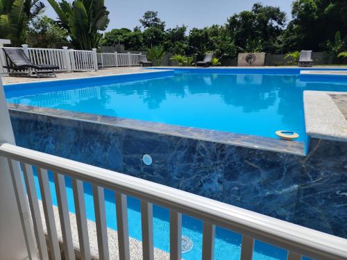 a swimming pool with blue water on a balcony at Bella Villa room with large pool and close to beach in Las Galeras