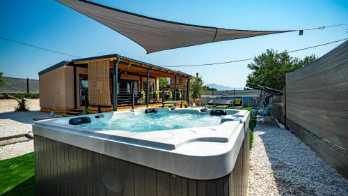 a hot tub in the backyard of a house at House Red Earth - Kastel Stafilic in Kaštela