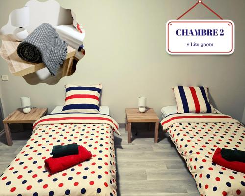 a room with two beds and a sign on the wall at Martel Medieval Le Gite de la rue Droite 3 in Martel