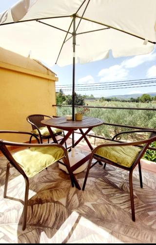 a table and chairs with an umbrella on a patio at B&B Casa Josa in Ontinyent