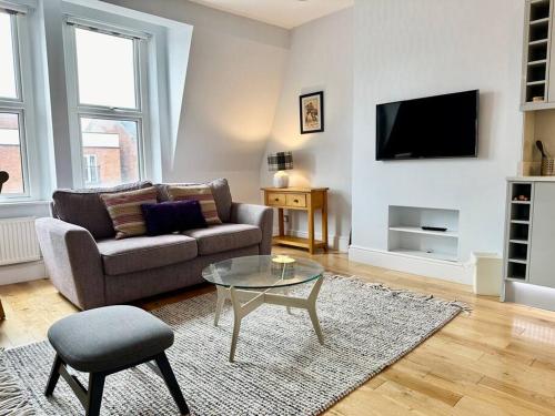 a living room with a couch and a table at Cozy Family Flat in Twickenham in Twickenham