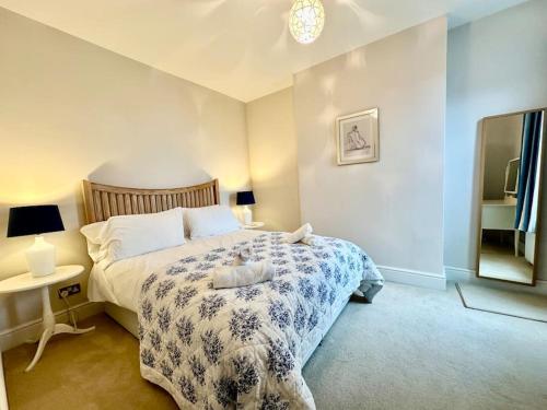 a bedroom with a bed and a mirror at Cozy Family Flat in Twickenham in Twickenham