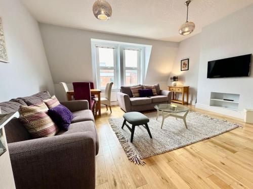 a living room with a couch and a table at Cozy Family Flat in Twickenham in Twickenham