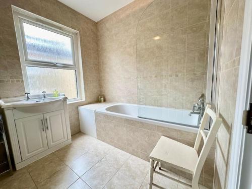 a bathroom with a tub and a sink at Cozy Family Flat in Twickenham in Twickenham