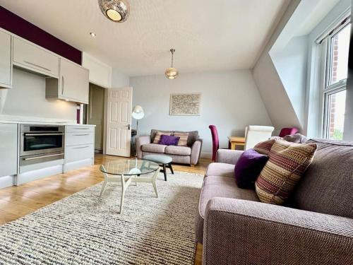 a living room with a couch and a table at Cozy Family Flat in Twickenham in Twickenham