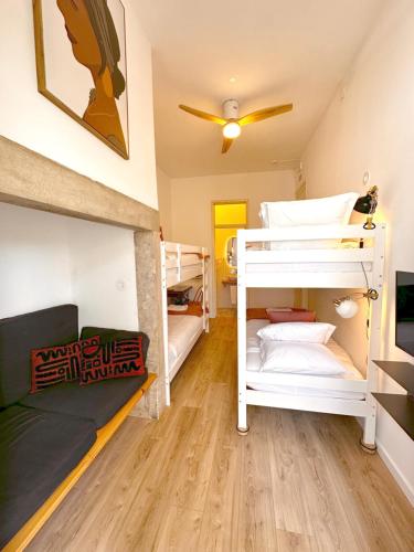 a room with two bunk beds and a couch at Lisbon Chillout Hostel in Lisbon