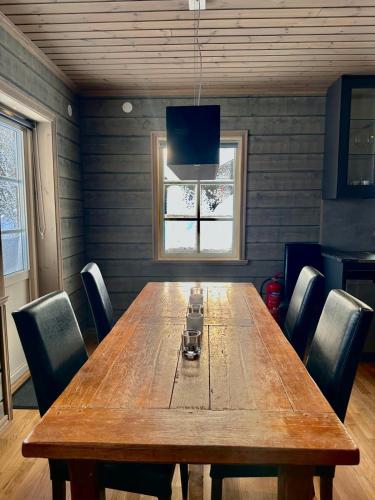 a large wooden table in a room with chairs at Mountain Birch - Fjäll Bjorken in Åre