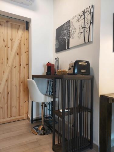 a room with a desk with a toaster and a chair at Bergamo - La Casa Di Gianna in Nembro