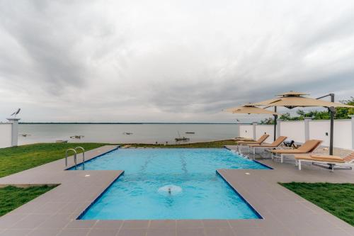 a swimming pool with a view of the water at Tulia Luxury Villas in Mkunguni