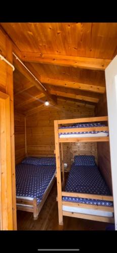 a room with two bunk beds in a cabin at White Houses Complex in Fier