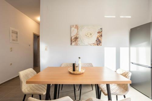a dining room with a wooden table and chairs at Filiatra Charming Urban Escape Your Cozy Retreat in Filiatra