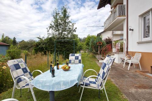a blue table and chairs on a yard at Familie Quednow - Im Algi in Görwihl