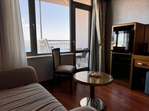 a living room with a couch and a table and window at Grand Star Hotel Premium in Istanbul