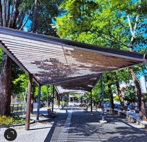 a wooden canopy in a park with a bench at FBM Anagenessis - Ευ Ζην in Edessa