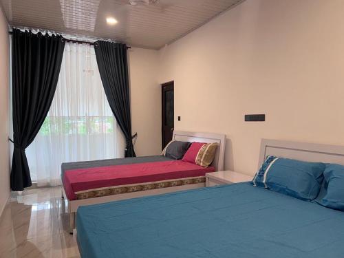 Postel nebo postele na pokoji v ubytování Trinco Caritas Guest Villa