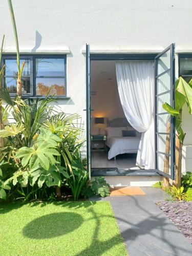 a bedroom with a bed and a window at The Little Limes - Ensuite Double Room Own Entrance in Art Deco House in Kent