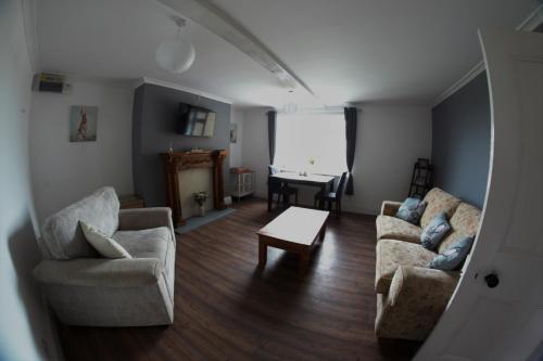 a living room with a couch and chairs and a table at Lingfield Lodge Ewenique Views pets welcome in Welbury