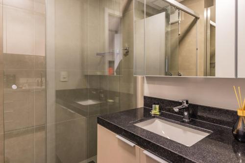 a bathroom with a sink and a shower at GO 24 by My Way in Porto Alegre