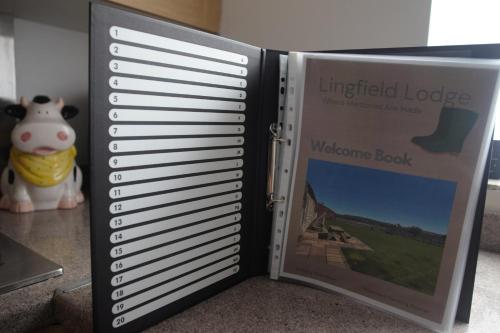 a book with a picture of a welcome book at Lingfield Lodge Ewenique Views pets welcome in Welbury
