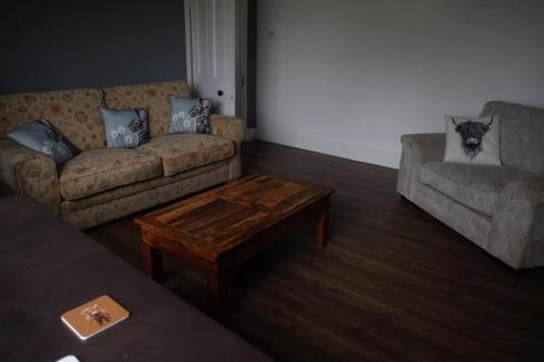 a living room with two couches and a coffee table at Lingfield Lodge Ewenique Views pets welcome in Welbury