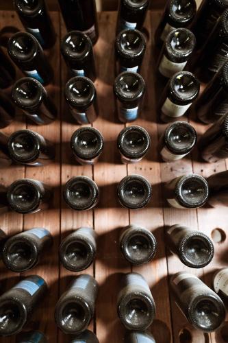 a bunch of wine bottles on a wooden table at Antica Masseria Martuccio in Mesagne