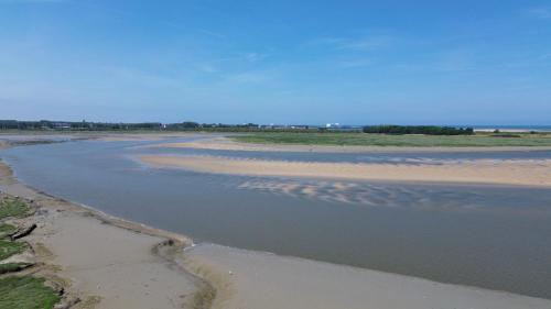 an aerial view of a beach with a body of water at Escapade à Cabourg, 300M plage, calme et chaleureux in Cabourg
