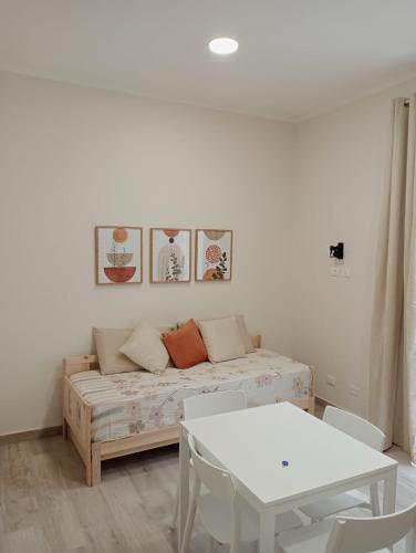 a living room with a couch and a table at Butterfly Apartments in Palermo