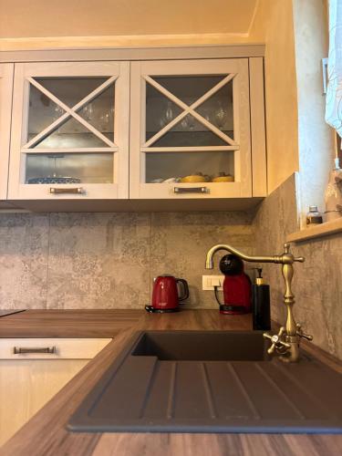 a kitchen sink with a faucet in a kitchen at Amor, flat with private hot tub, breathtaking views and free parking in a garage, bookable all year round, Also take a look at our flat Coccolina in Rabac