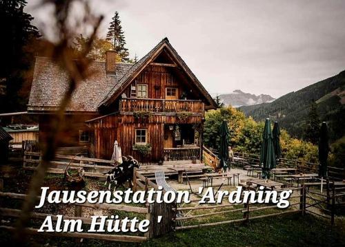 a wooden house with the words japanisationanntaining aim at Ferienwohnung " Esserhof " Nationalpark Gesäuse in Ardning
