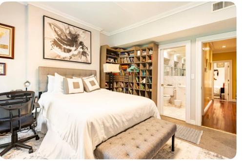 a bedroom with a bed and a desk and a chair at TOWNHOUSE 222 in New York