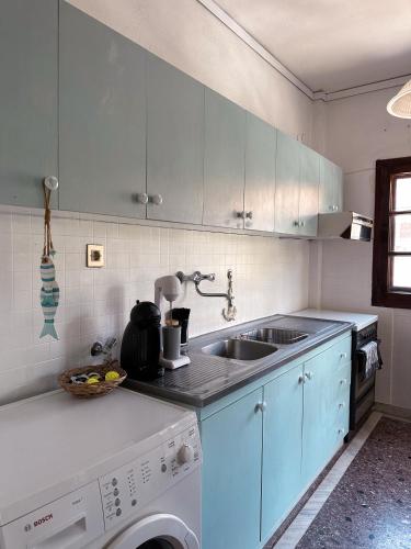 a kitchen with a sink and a washing machine at Sugar V 28 in Vergia