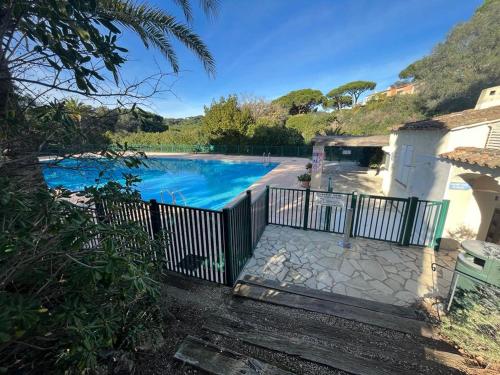 une piscine avec une clôture à côté d'une maison dans l'établissement MAS DE SAINT TROPEZ GIGARO, à La Croix-Valmer