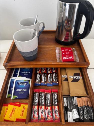 a wooden shelf with books and a cup and a blender at Seacrest Guest House in Weymouth