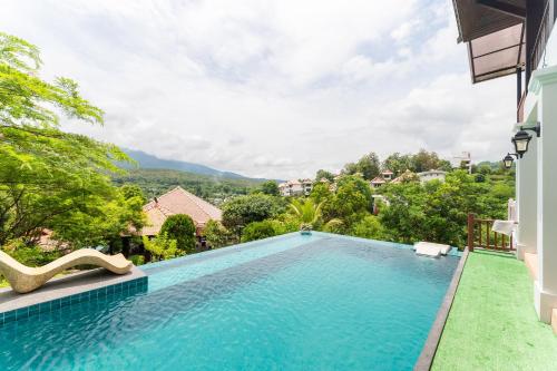 a swimming pool in a villa with a view at Guru Resort Chiang Mai in Ban Muang Ha